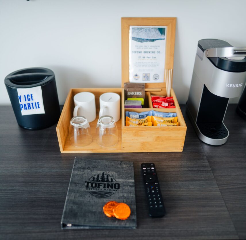 Locally curated snacks, mugs, and coffee setup in hotel suite