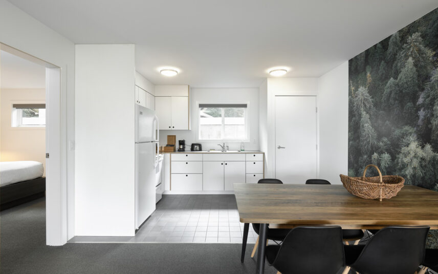 Dining table and kitchenette area in a king suite with natural wood accents