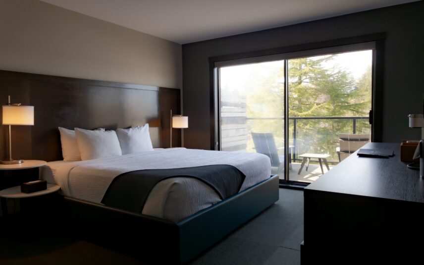 Cozy, clean, and modern hotel room in Tofino with balcony and large window