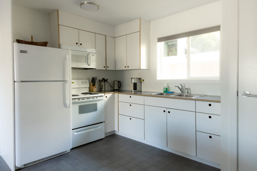 Hotel kitchenette with residential sized fridge and range in the heart of town