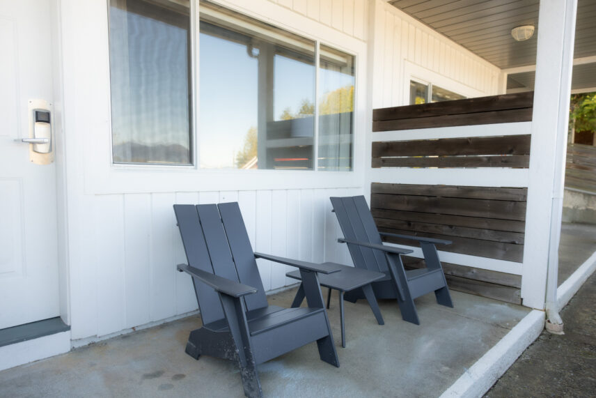 Lounge chairs right outside the Tofino hotel room with kitchenette on the harbour