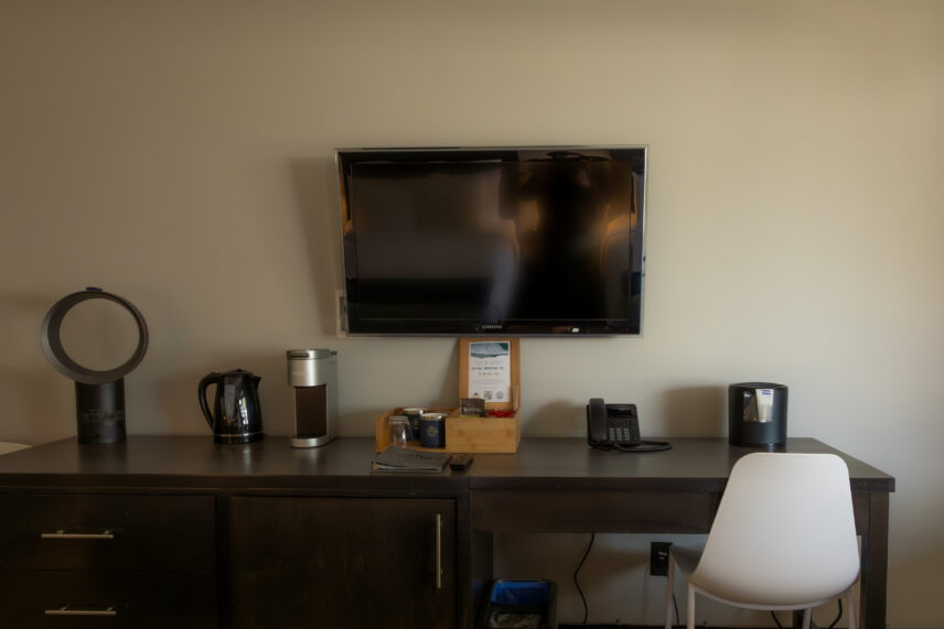 Tofino hotel TV bar with Keurig, kettle, Dyson air fan, and coffee and snacks