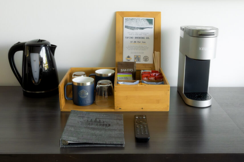 Locally curated snacks, mugs, and coffee setup in hotel suite