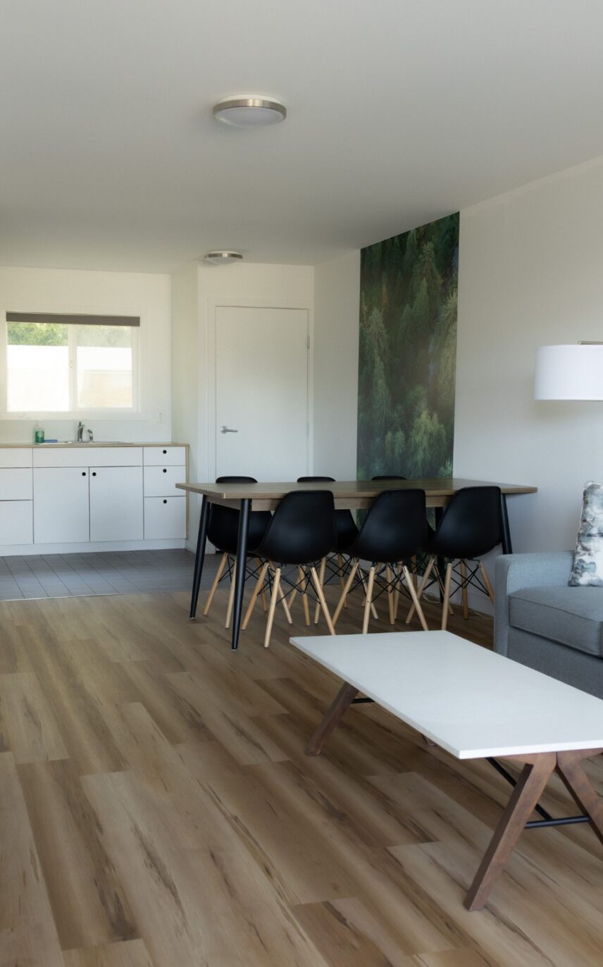 Dining table and kitchenette area in a king suite with natural wood accents