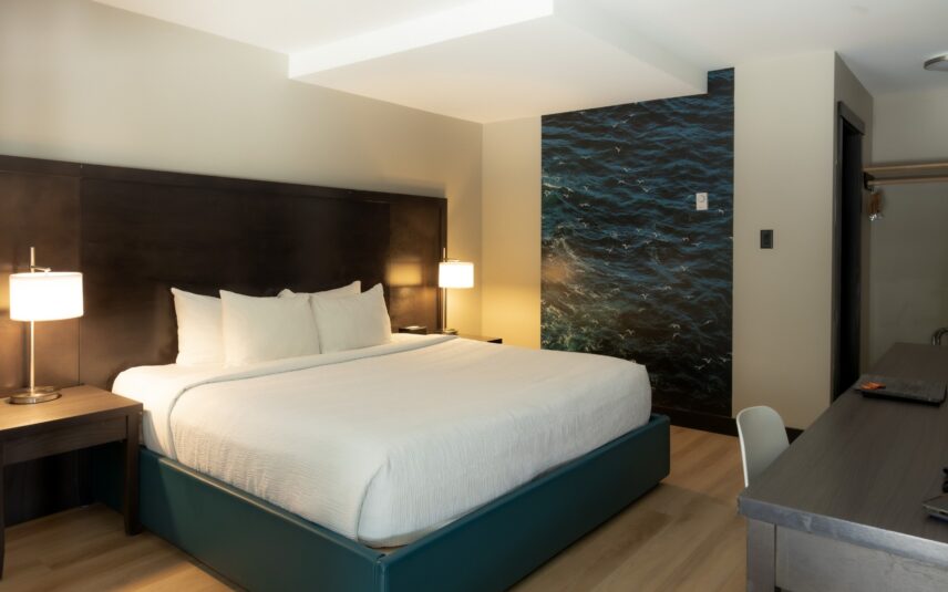 Cozy king bed in a bright, west coast inspired hotel room