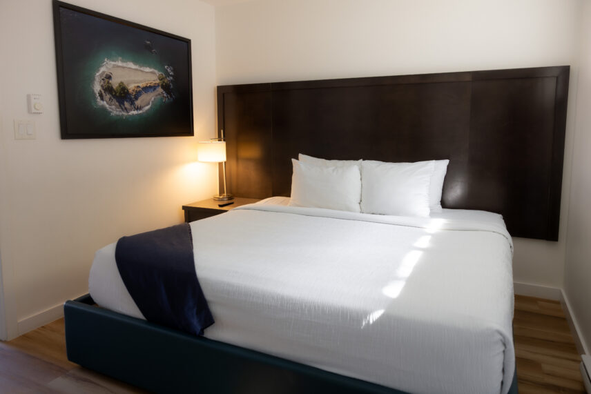 Tofino hotel suite king bed with modern feel featuring coastal art