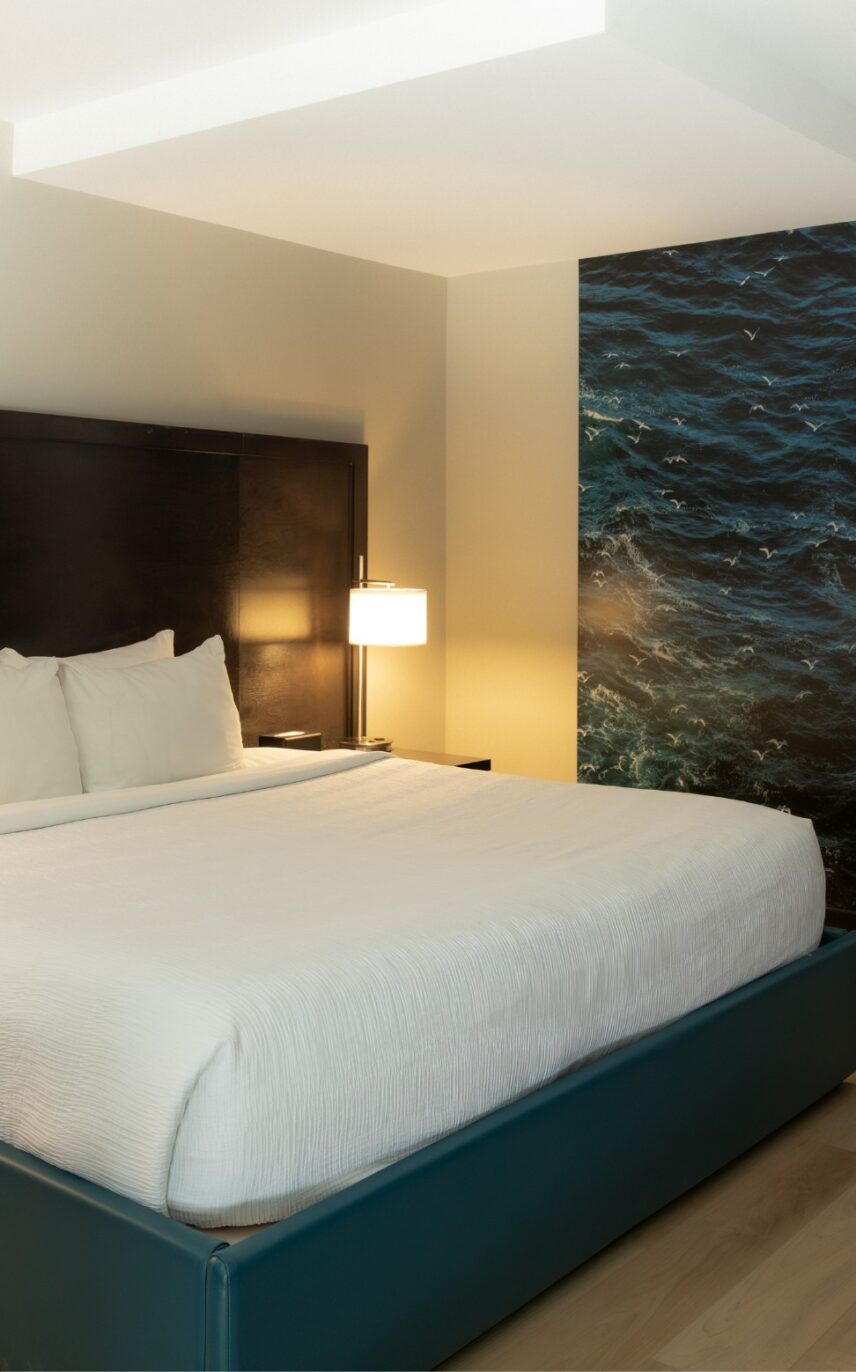 Cozy king bed in a bright, west coast inspired hotel room