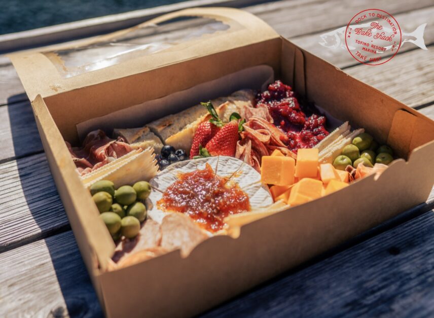 A delicious looking charcuterie board in a to-go box for Tofino tour floating sauna