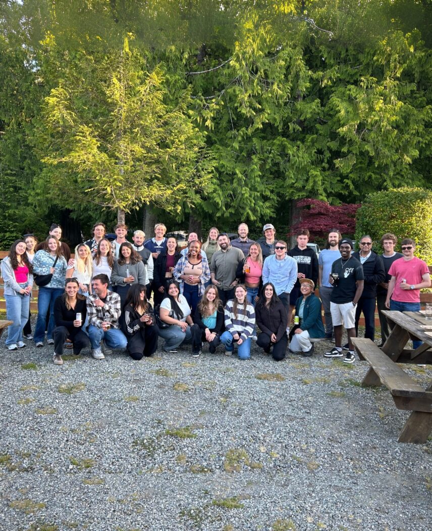 TRM staff group photo outside with trees