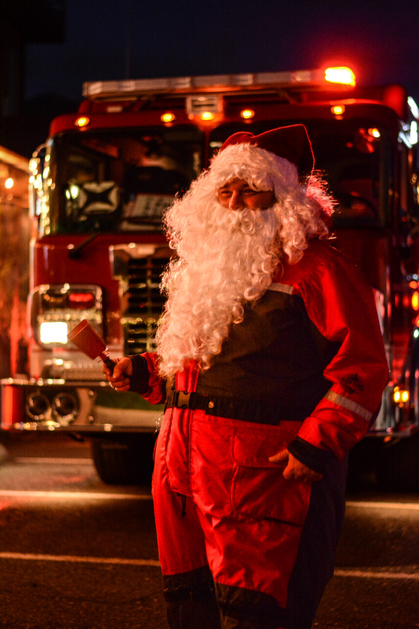 Santa Claus in front of a firetruck
