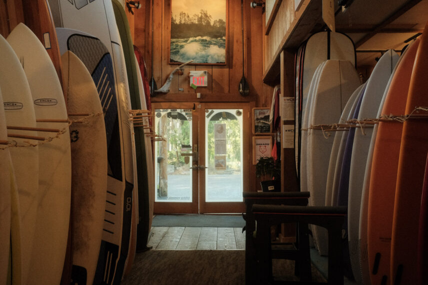 surf board racks filled with boards at a surf shop