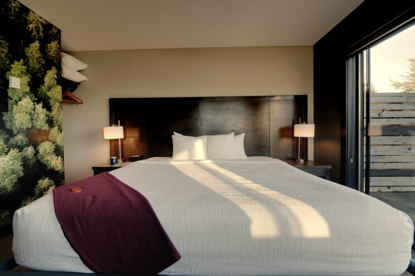 comfy king bed in hotel room with natural light