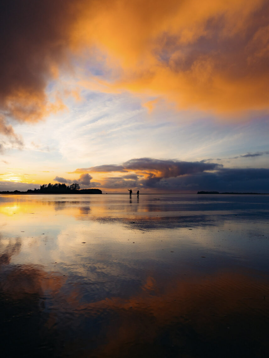 sunset over the ocean reflecting on the wet sand
